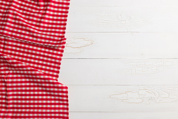 Red towel over wooden kitchen table.