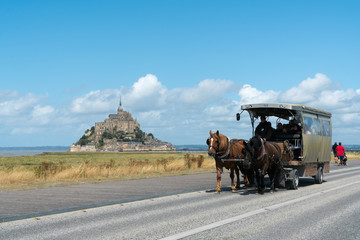 horse and carriage transporting tourists to the famous Mont Saint-Michel in northern France