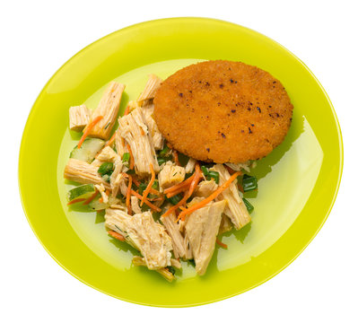 fishcake with soy asparagus and carrots, cucumbers and dilll.  fish cutlet on a plate isolated. cutlet with vegetables top view