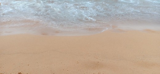 white waves on the golden sand in the beach sea background image