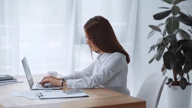 side view of businesswoman having backache in office