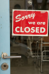 Retro red sorry we are closed sign on a door