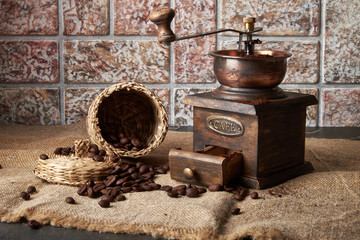 still life of coffee beans in jute bags with coffee grinder