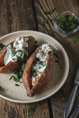 Baked sweet potato with cream cheese, yogurt and fresh herbs