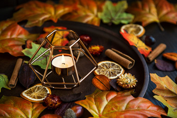 Fall candle decoration with dried leaves