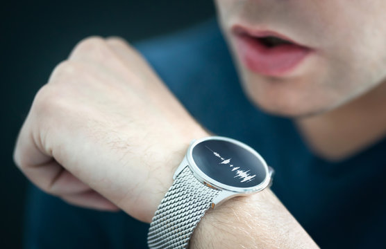 Voice Recording Or Speech Recognition Technology In Smart Watch. Man Talking To Smartwatch Mic And Recorder. Personal Assistant App To Give Command Or Send Message. Modern Wearable AI Sound Tech.