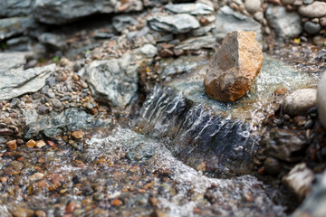 splashes and drops of a stream running over stones