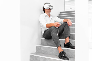 Man wearing virtual reality goggles in modern bright co-working office. the VR experience.