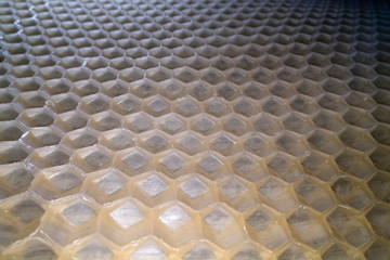 Wide angle macro shot of honeycomb wax. Abstract view of honey comb hexagon shape pattern
