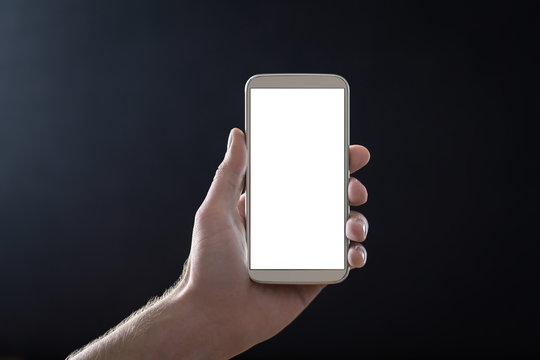 Empty mobile phone screen with dark black background in shadow at night. Hand holding smartphone with blank white display and copy space. Man showing cellphone straight to camera. Digital mockup.