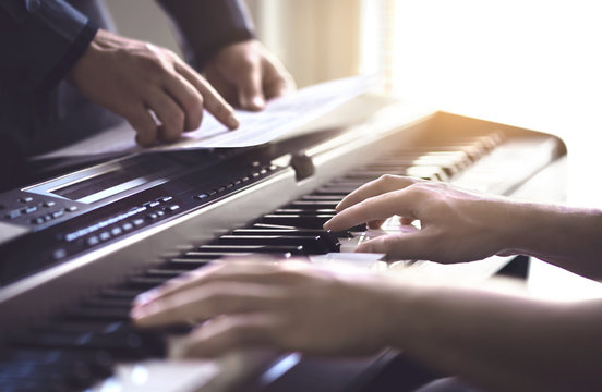 Piano Teacher And Student Practising. Music Lesson And Course In School. Man Learn Playing With Tutor In Class. Mentor Teaching Pianist. Band Practise. Two Guys Training. Hobby And Education Concept.