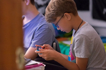 close up of boy playing videogames and holding a controller - type of hobby and entertainment for all people - indoor and at home concept