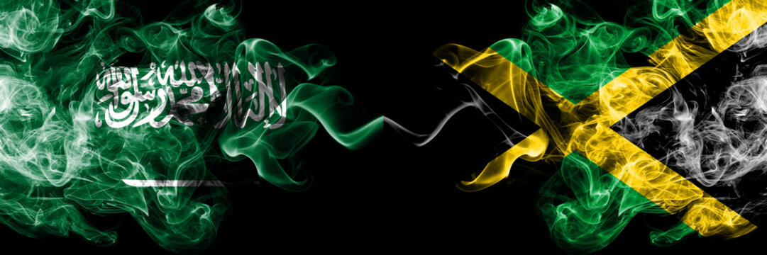 Saudi Arabia Kingdom vs Jamaica, Jamaican smoky mystic flags placed side by side. Thick colored silky smoke flags of Arabic, Arabian and Jamaica, Jamaican