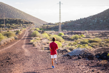 teenager running alone and siolated in mountain to be a fitness boy and be healthy - jogging to lose weight