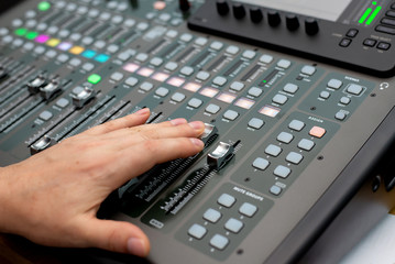 the mixer. remote for sound recording. sound engineer at work in the studio. sound amplifier mixing console equalizer. DJ