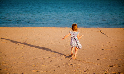 little girl running to the sea