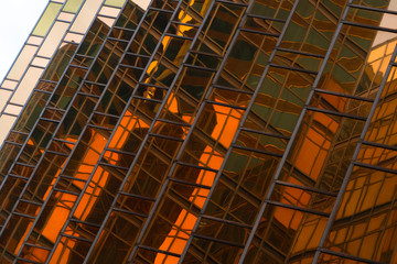 Golden building. Windows glass of modern office skyscrapers in technology and business concept....
