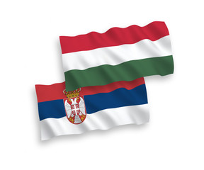 National vector fabric wave flags of Serbia and Hungary isolated on white background. 1 to 2 proportion.