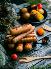 Grilled sausages and grilled vegetables in rustic style