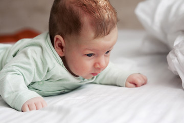 cute newborn baby in bed at home