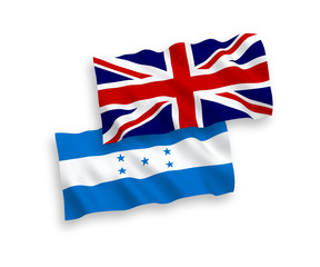 National vector fabric wave flags of Great Britain and Honduras isolated on white background. 1 to 2 proportion.