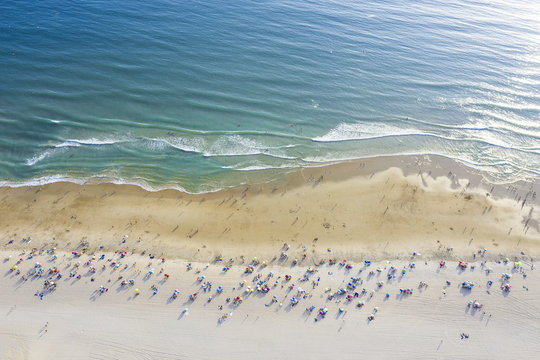 aerial view of a beach with umbrellas and tourists