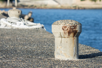 Naklejka premium Concrete mooring bollard at a dock. 