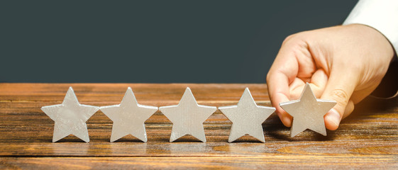 Critic puts the fifth star. The concept of the rating of hotels and restaurants. The evaluation of...