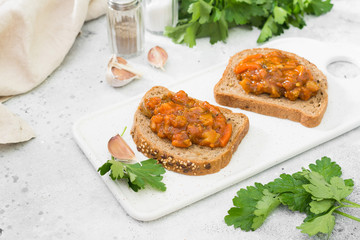 Vegetable caviar in a white bowl on a light gray table