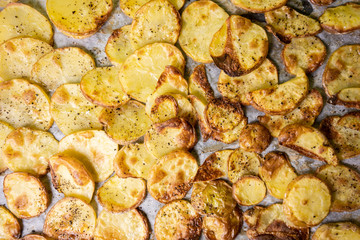 Baked Potatoes on a tray with black pepper