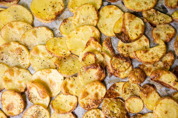 Baked Potatoes on a tray with black pepper