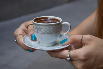 woman holding a cup of coffee in her hands