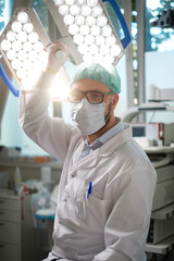 Male asian surgeon in operation room with his team