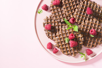 Waffles with chocolate on a pink plate