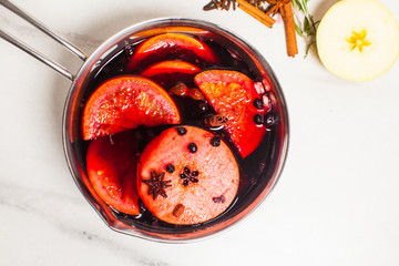 Red wine with citrus, apple and spices cooked in casserole