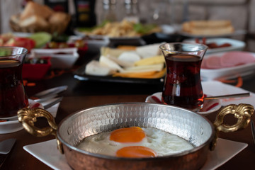 Fototapeta na wymiar Fried egg with traditional Turkish breakfast and tea