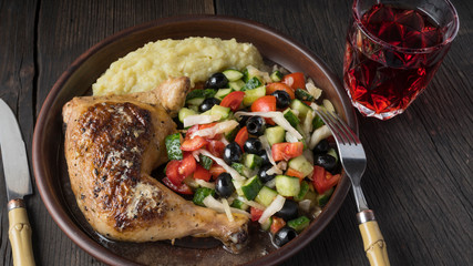 Lunch on the same plate. Juicy fried chicken with mashed potatoes and salad served with wine. Complete lunch.