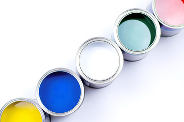 Five cans of multicolored paint on a white background.