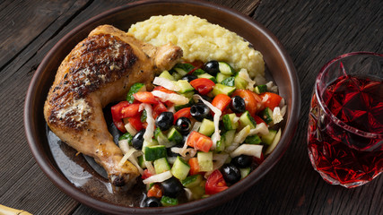 Lunch on the same plate. Juicy fried chicken with mashed potatoes and salad served with wine. Complete lunch.