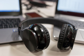 Fototapeta na wymiar Laptops and wireless headphones in an office environment