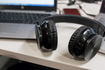 Obraz na płótnie Canvas Laptops and wireless headphones in an office environment