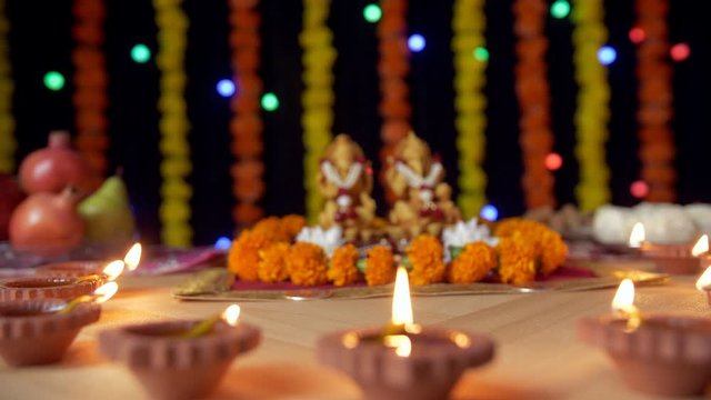 Beautiful oil lamps with Lord Ganesha and Goddess Lakshmi for Diwali Pujan. Burning Diyas decorated around Ganesh Ji and Laxmi Ji on the occasion of Diwali  also known as the festival of lights - B...