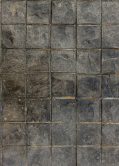 Seamless texture of black stones. Background texture of textured square floor ceramic tiles. Cobblestone background.