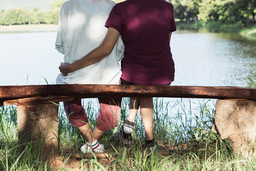 Mother hugging her daughter of happy, love concept in nature background.