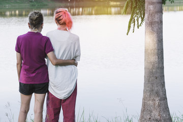 Mother hugging her daughter of happy, love concept in nature background.