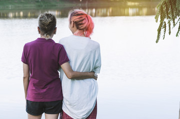 Mother hugging her daughter of happy, love concept in nature background.