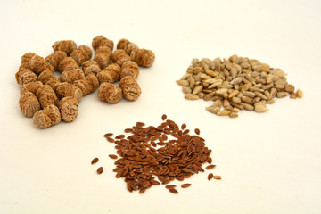 Cereals and seeds: sunflower, flax and bran closeup on a white background