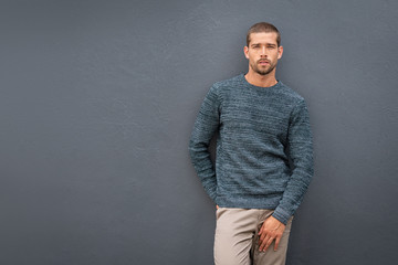 Casual fashionable man against grey wall