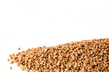 Raw uncooked buckwheat seeds on white background