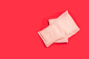 sanitary tampons and pads on a red background